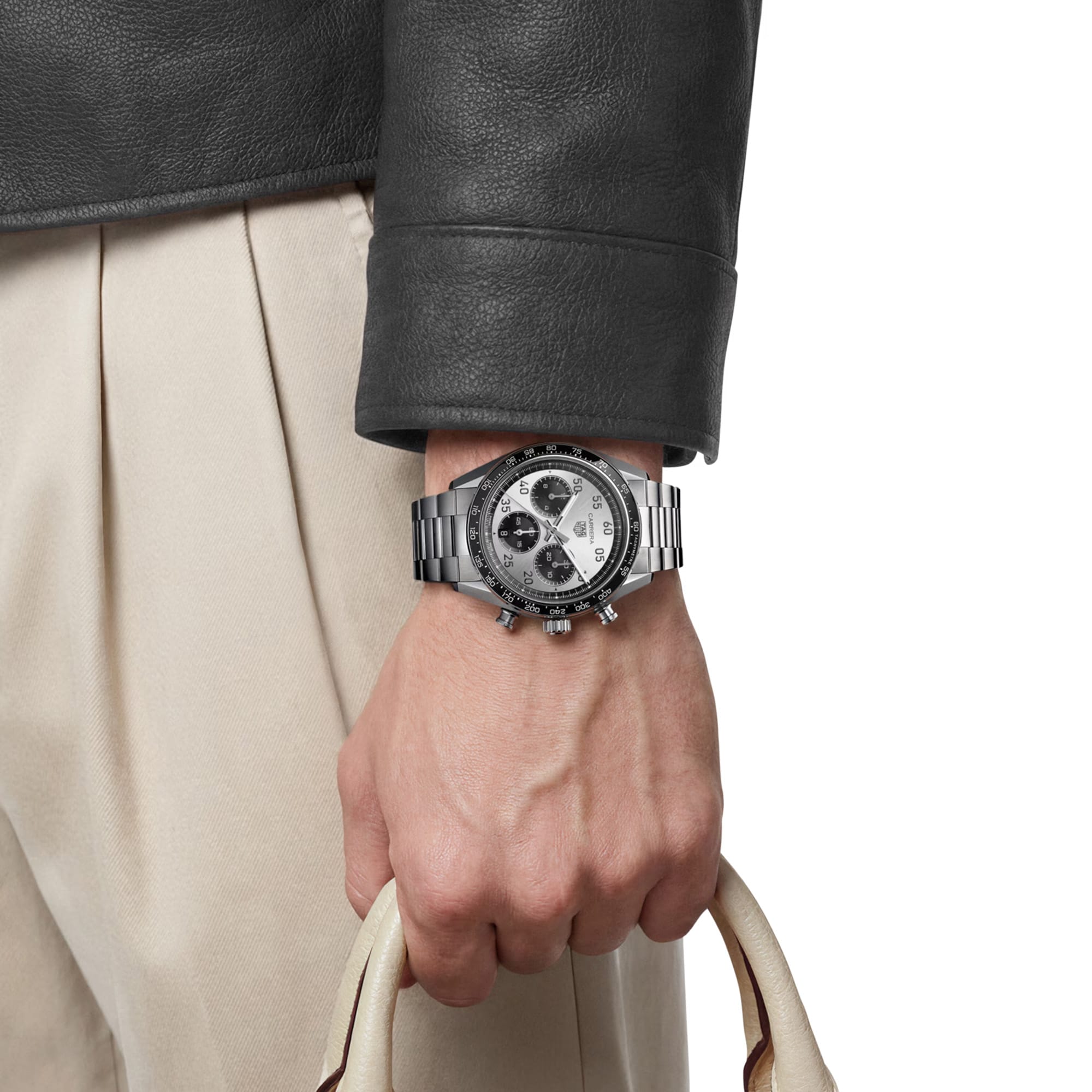 TAG Heuer Carrera Chronograph Sport CDB2113.BA0054 shown worn on the wrist, illustrating the case proportions and steel bracelet fit. The silver dial stands out against the sleeve in frame.