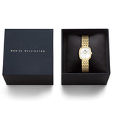 The Daniel Wellington Corta Grain-Link Women’s 24mm Quartz Watch DW00100993 displayed in its Daniel Wellington presentation box. The gold cushion case, white dial and grain-link bracelet are presented ready for gifting.