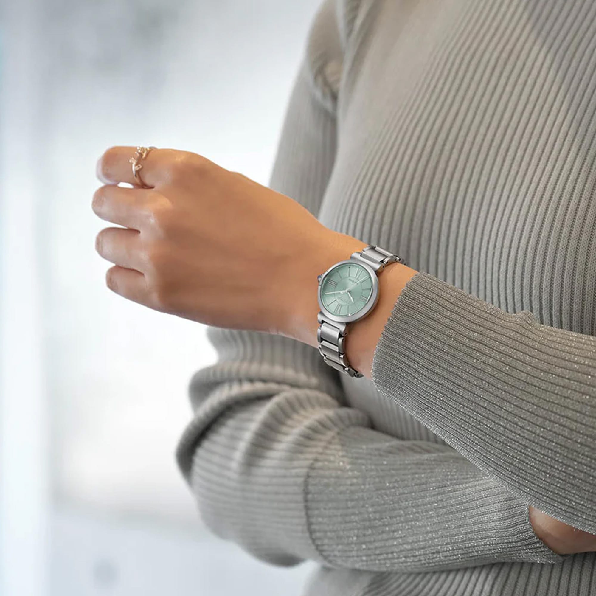 The Citizen L May Bells EM1070-83L styled for everyday wear, reflecting its Eco-Drive solar-powered design. Its pale green dial suits both casual and more formal settings.