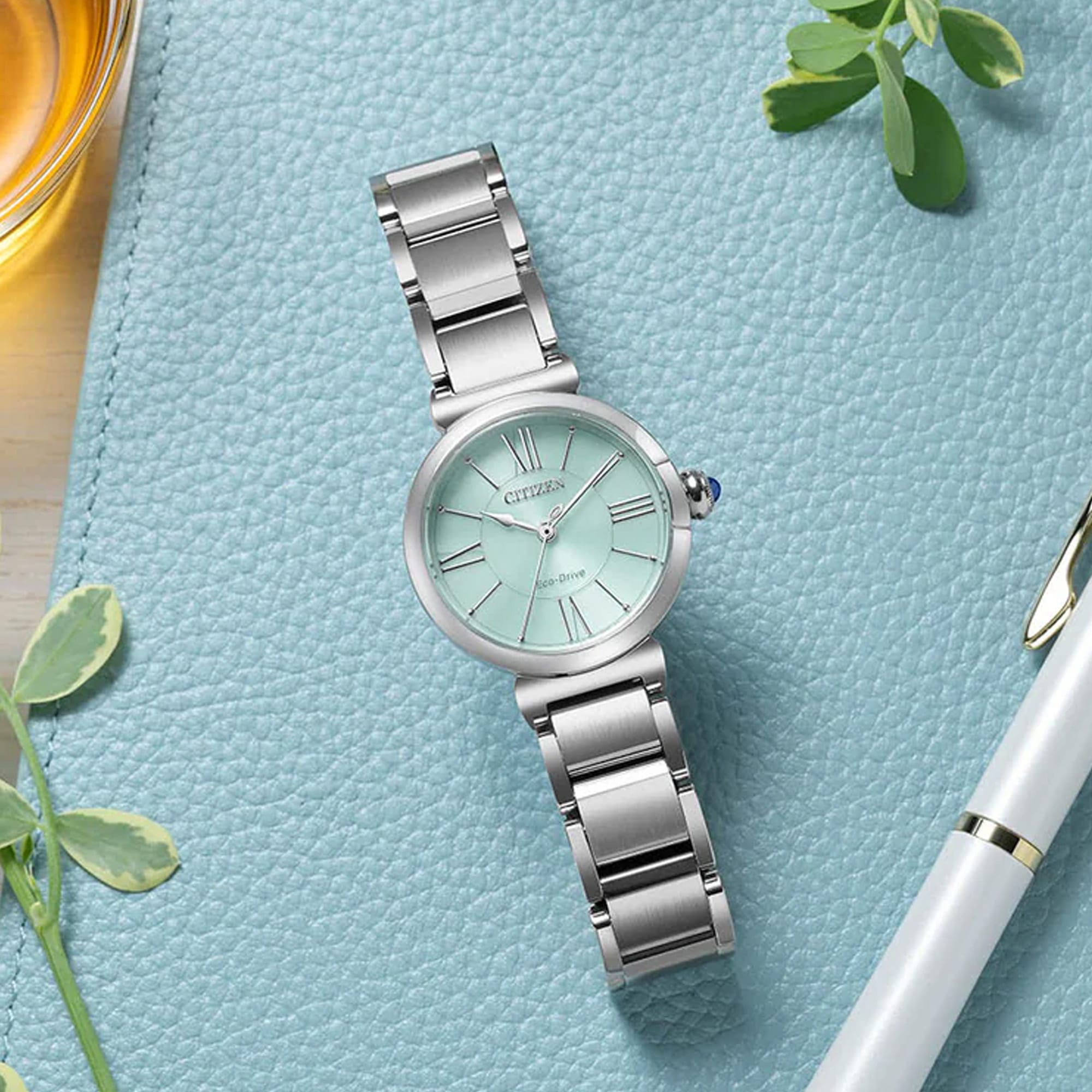 The Citizen L May Bells EM1070-83L styled for everyday wear, reflecting its Eco-Drive solar-powered design. Its pale green dial suits both casual and more formal settings.