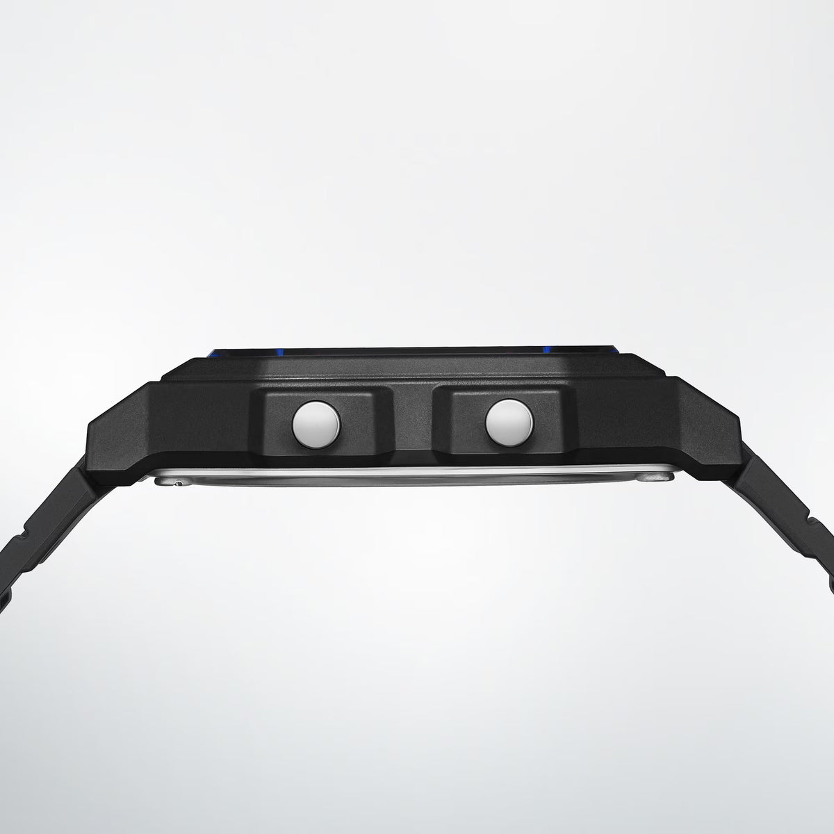 Side profile of the Casio Vintage Digital Watch F-B100W-1A, showing the slim black resin case depth. The bio-based resin strap is visible along the watch's profile.