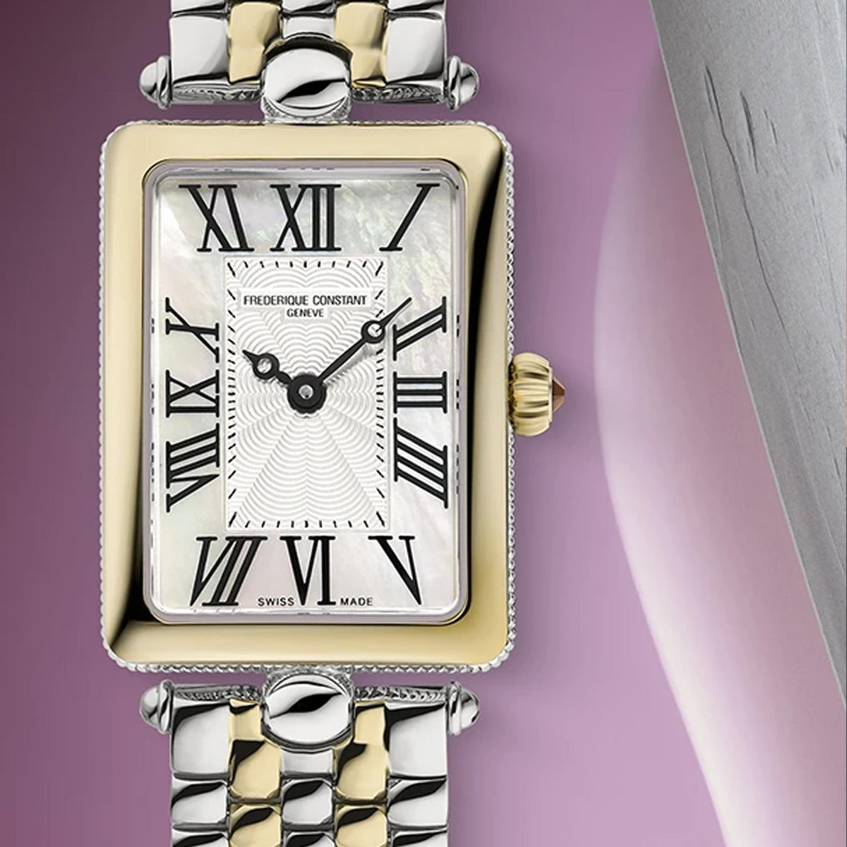 A close-up studio shot of a Frederique Constant wristwatch with a rectangular two-tone metal case and bracelet. The watch features a white mother-of-pearl dial with black Roman numerals and a gold crown.