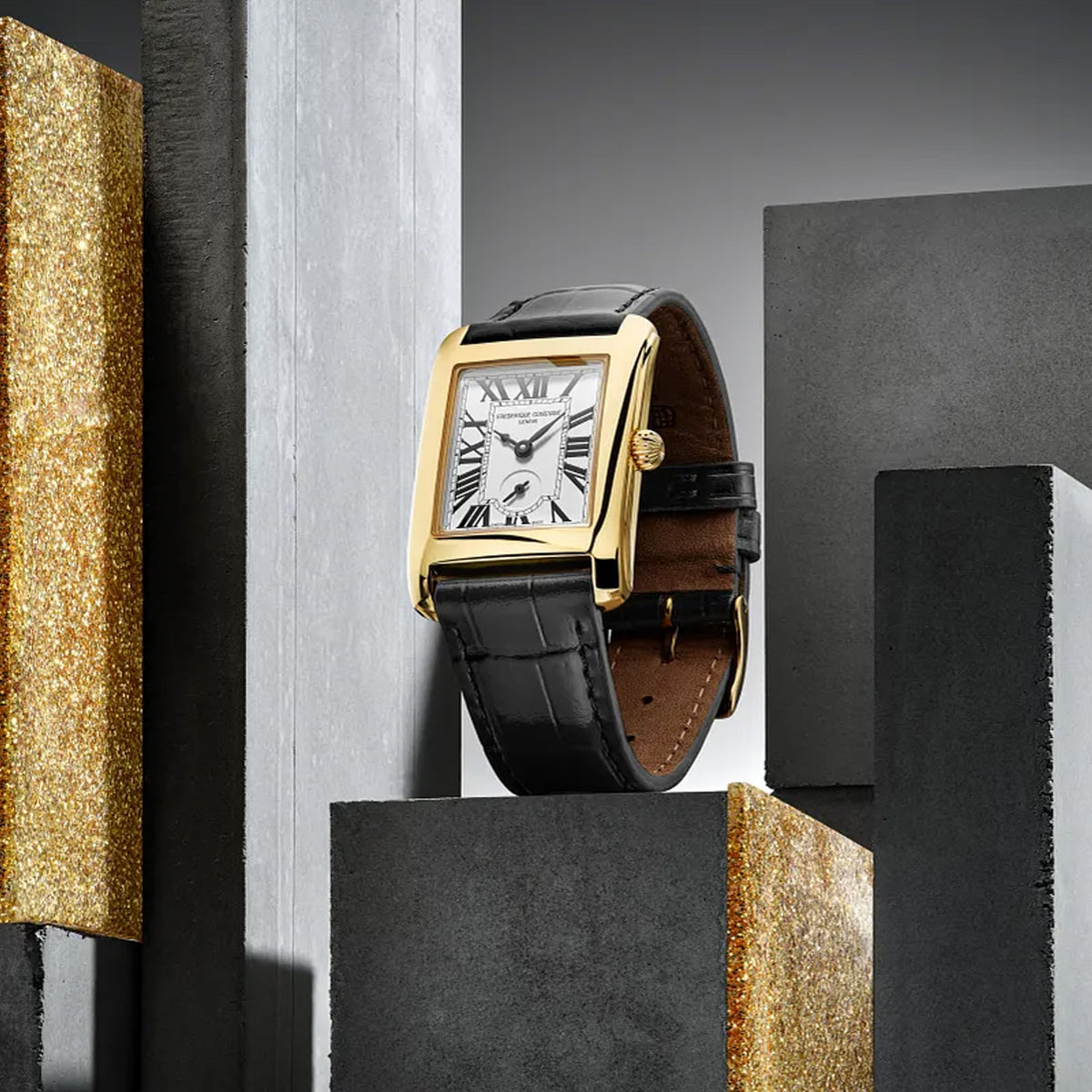 Frederique Constant Carrée Quartz Watch FC-235S2C5 styled in a lifestyle setting, reflecting its Art Deco-inspired design suited to both everyday and formal occasions. The gold-tone finish and white dial complement a refined, vintage-influenced look.