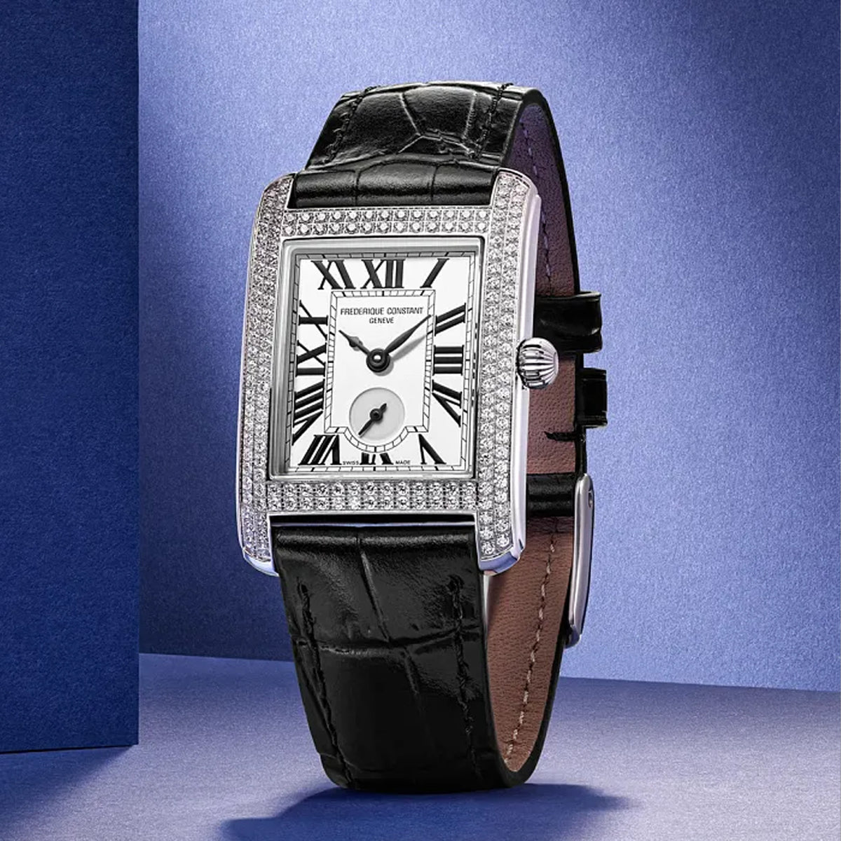Frederique Constant Classic Quartz Women's 36mm Watch FC-235S2CD6 styled in a lifestyle setting, reflecting its glamorous, Art Deco-inspired design suited to evening and formal occasions. The diamond-set bezel and silver dial complement a refined, luxurious look.
