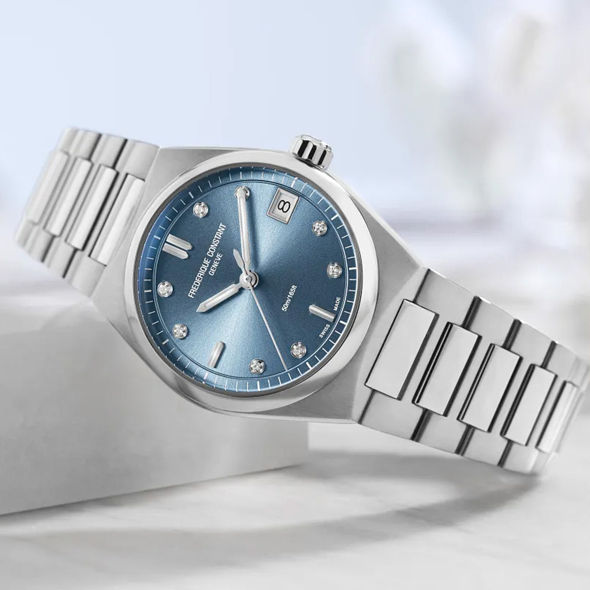 Frederique Constant Highlife Women's 31mm Quartz Stainless Steel Watch FC-240LND2NH26B styled in a lifestyle setting, reflecting its versatile design for both everyday and dressier occasions. The icy blue dial and stainless steel case complement a range of outfits.