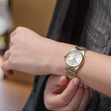 Frederique Constant Highlife Women's 31mm Quartz Watch FC-240VD2NH3B worn on the wrist, demonstrating the fit of its 31mm case and integrated two-tone bracelet. The watch can also be worn on the included rubber strap for a sportier look.