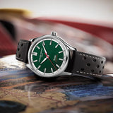 Frederique Constant Classic Men's 40mm Chronometer Watch FC-301HGRS5B6 styled in a lifestyle setting, reflecting its vintage motorsport-inspired design suited to casual and smart-casual wear. The green dial and brown leather strap suit a classic, heritage-driven look.