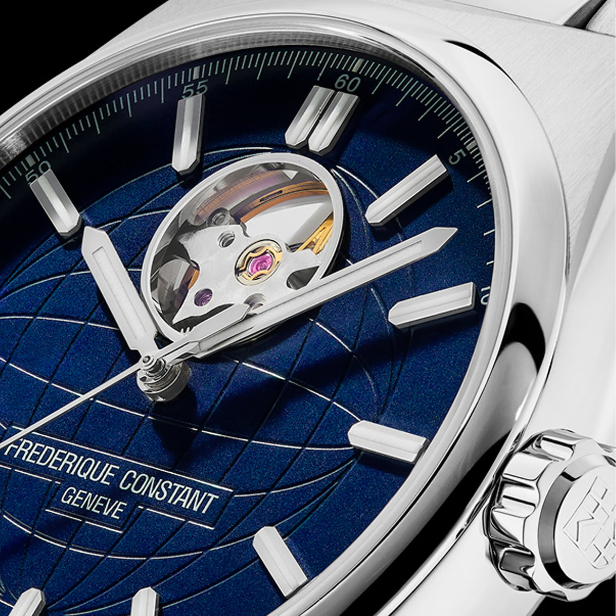Close-up of a Frederique Constant wristwatch with a deep blue sunburst dial, silver-tone case, and visible tourbillon mechanism.