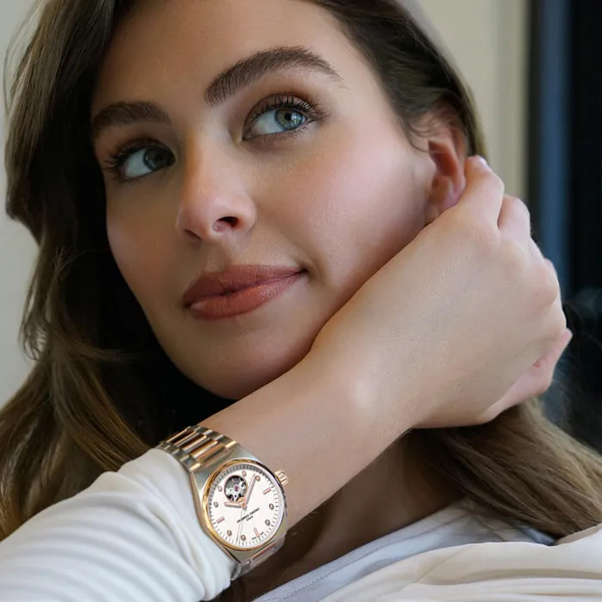 Frederique Constant Highlife Automatic Women's 34mm Watch FC-310VD2NH2B worn on the wrist, demonstrating the comfortable fit of its 34mm case and two-tone integrated bracelet. The watch can also be worn on the included pink rubber strap for a sportier look.