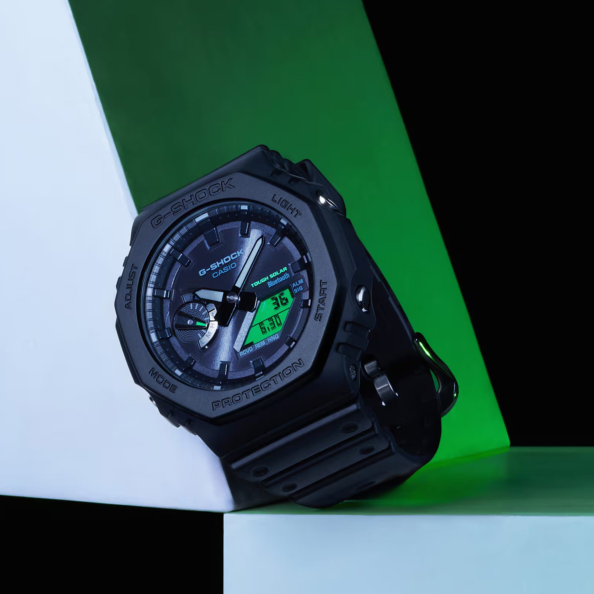 Casio G-Shock GAB2100BEG-1A front view showcasing the slim 11.9mm octagonal black bio-based resin case with electro green digital LCD window, dual-layer inset dial with textured surface treatment, analogue hands with Neobrite lume, and G-Shock branding — the iconic CasiOak silhouette in black and electro green.