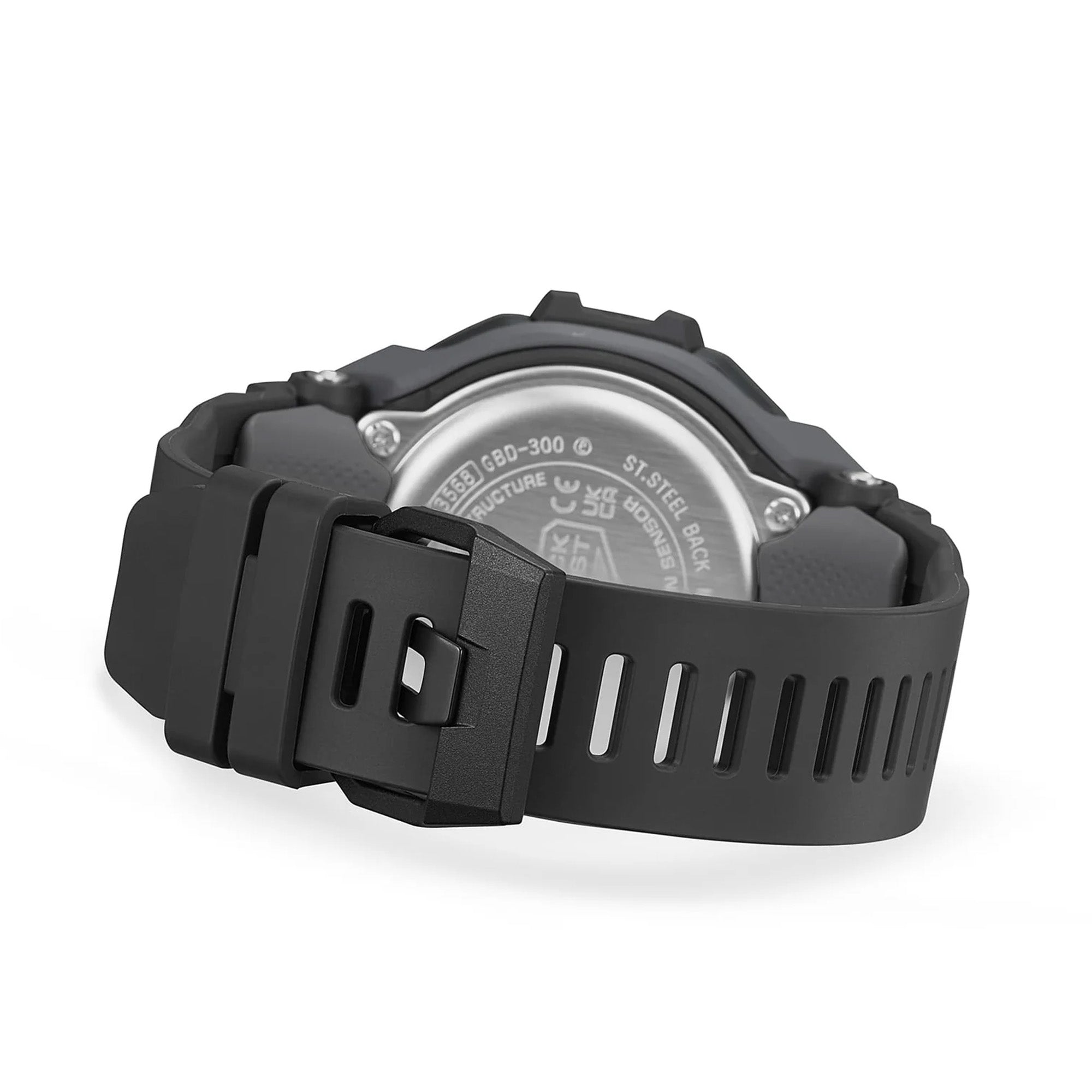 Casio G-Shock GBD300-1 close-up of the all-black bio-based urethane band with dotted skin-contact texture, flexible fine-resin underside covering, 5mm-interval adjustment holes for a precise fit, and a standard buckle clasp.