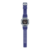 Casio G-SHOCK G-LIDE GBX100S-2D digital watch front view, featuring a square-case design with a dual-material bezel of stainless steel and translucent purple resin, high-definition MIP LCD display, and silver-tone accents.