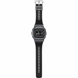 Casio G-LIDE GBXH5600-1D Black Digital Watch shown in a full-length vertical view displaying the complete strap and case. Square black resin case with digital dial and integrated band visible from top to bottom.