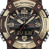 Close-up of the dial on the Casio G-SHOCK Mudmaster Analogue Digital Men's Watch GG-B100XMH-5A, 51mm case, showing the analogue hands, digital display and gold-toned hour markers against the black dial. The brown ion-plated bezel detailing is also visible.