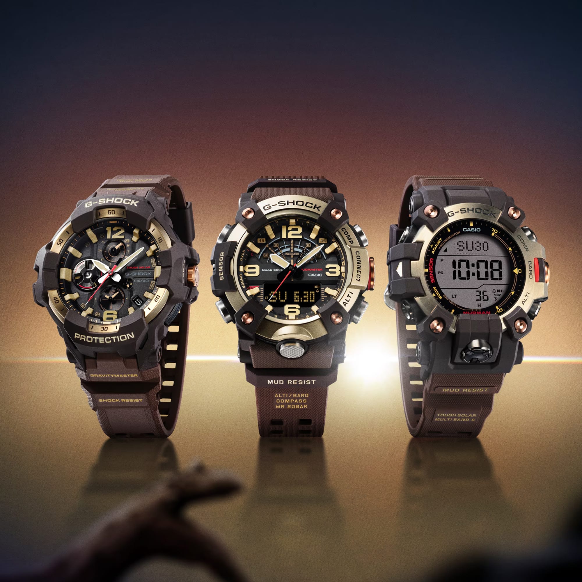 The Casio G-SHOCK Mudmaster Analogue Digital Men's Watch GG-B100XMH-5A shown alongside two other watches from the Master in Horizon Gold collection, the GravityMaster GR-B300H-5A and the Mudman GW-9500MH-5. All three share the collection's signature brown and gold ion-plated finish.