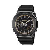 The Casio G-Shock Analogue Digital Men's Watch GM2100LXB-1A9 features a deep matte black anti-reflective textured dial with gold vapour-deposited hour markers, gold-edged slim extended hands, gold decorative frame around the glass, and gold G-Shock logo, set within a 49.3mm octagonal black ion-plated stainless steel bezel.