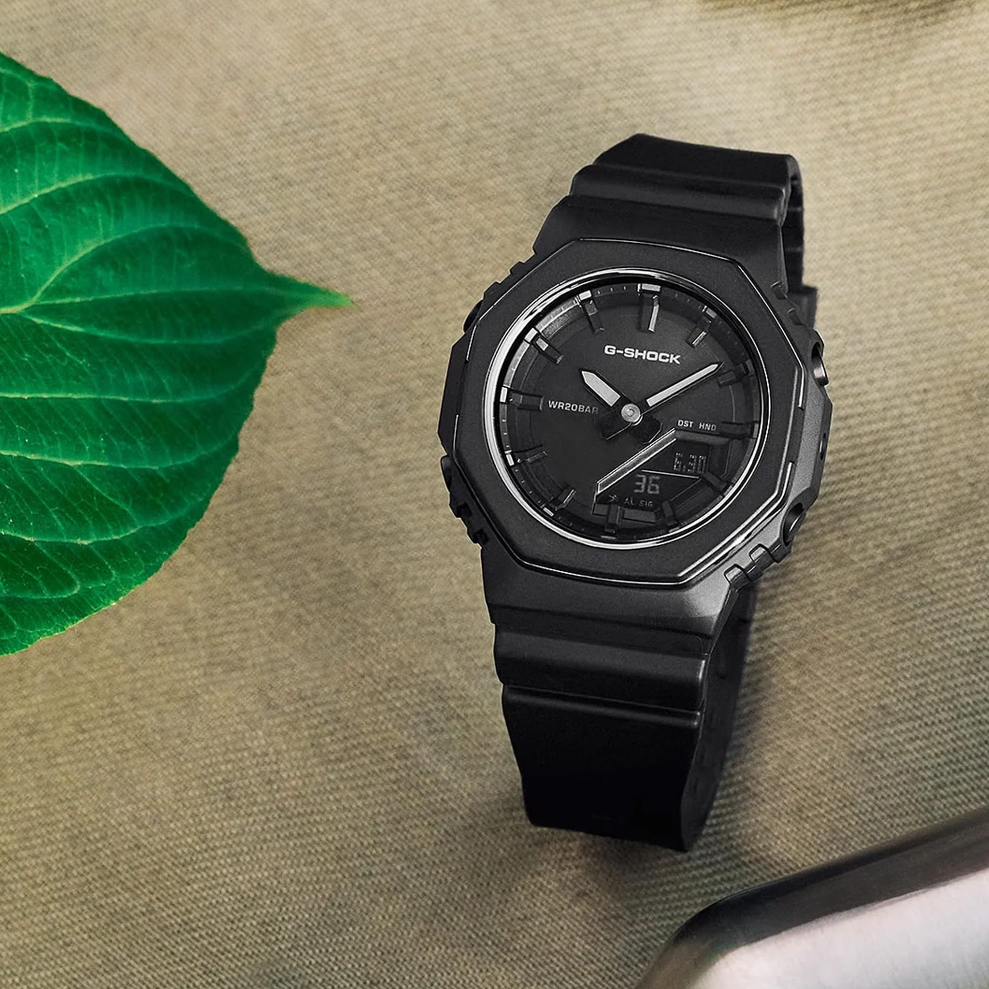 Lifestyle shot of the Casio G-SHOCK Analogue Digital Women's Watch GMA-P2110B-1A, 40.5mm case, styled in an everyday active setting. The compact all-black design is shown in a natural, real-world context.