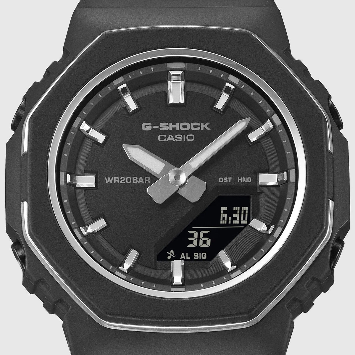 Close-up of the dial on the Casio G-SHOCK Analogue Digital Women's Watch GMA-P2110B-1A, 40.5mm case, showing the analogue hands, digital display and the light-catching metal bezel ring. The matte black finish is shown in detail.