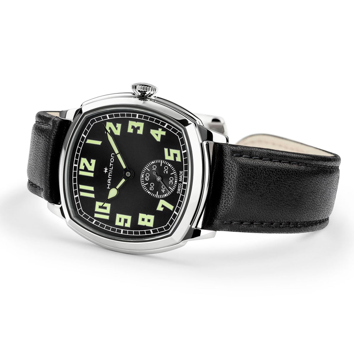 Hamilton American Classic Cushion Mechanical Unisex 34mm Watch H36129730 is captured at a 3/4 angle, showing the black dial, steel case and black leather strap together. The angle highlights the soft cushion shape of the case.