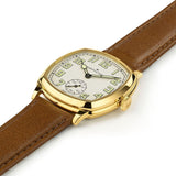 Hamilton American Classic Cushion Mechanical Unisex 34mm Watch H36139520 is captured at a 3/4 angle, showing the beige dial, yellow gold PVD case and brown leather strap together. The angle highlights the soft cushion shape of the case.