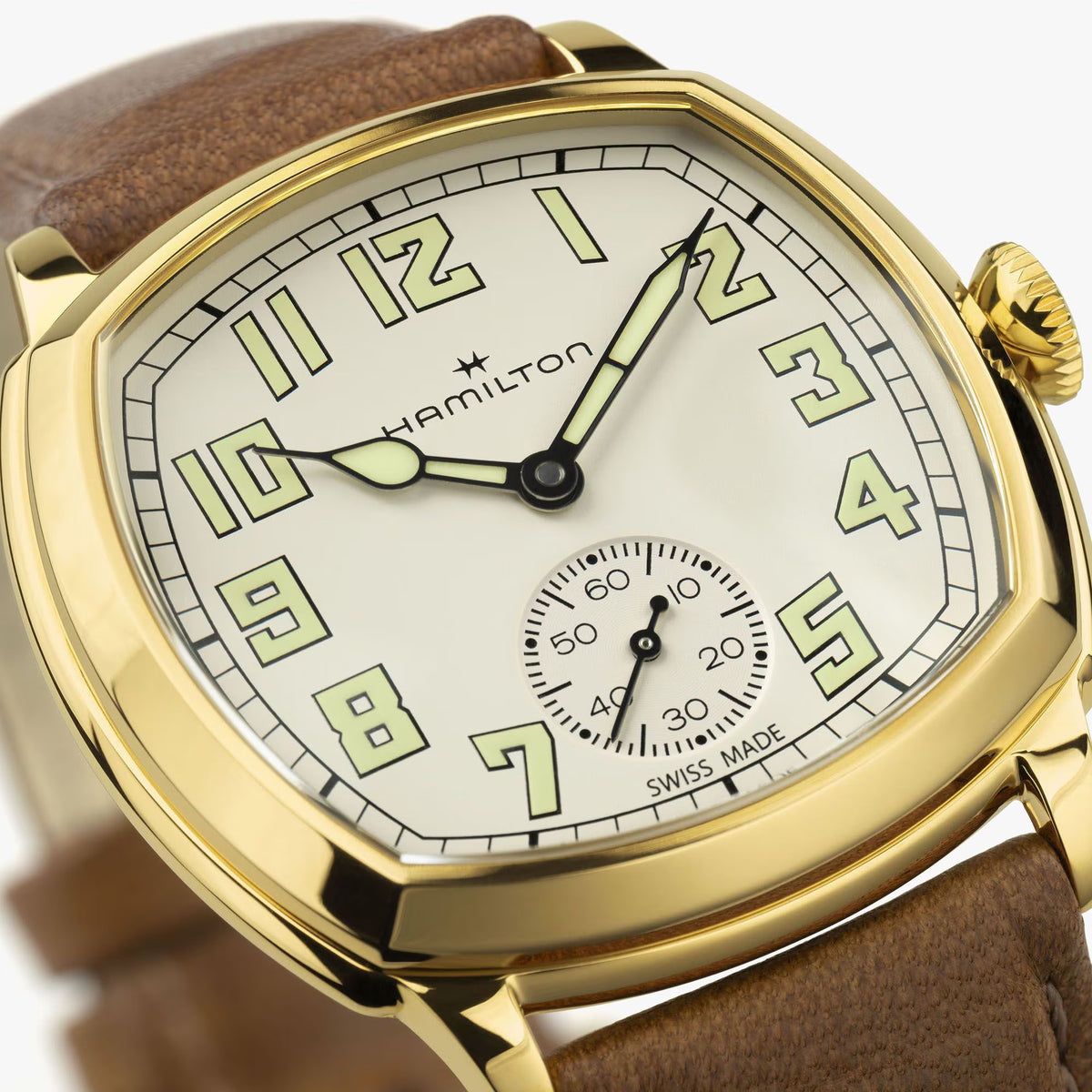 Hamilton American Classic Cushion Mechanical Unisex 34mm Watch H36139520 is shown in close up, revealing the Arabic numerals, railway minute track and small seconds sub-dial. The slim hands stand out against the beige dial.