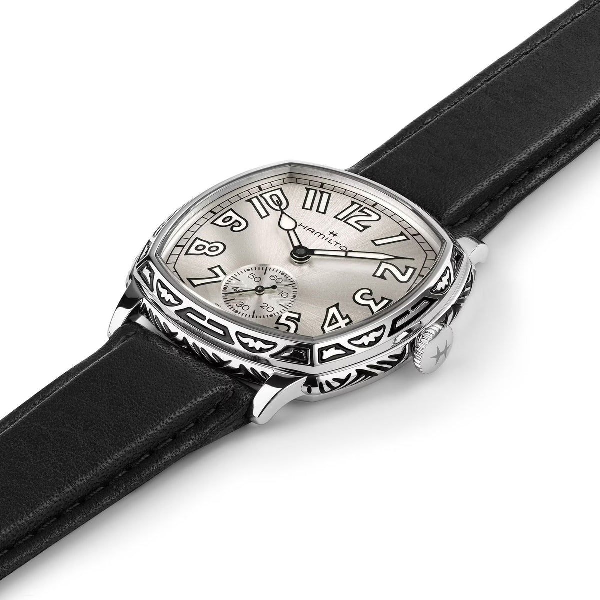 Hamilton American Classic Cushion Mechanical Unisex 34mm Watch H36149710 is captured at a 3/4 angle, showing the white dial, steel case and black leather strap together. The angle highlights the soft cushion shape and the engraved case finish.