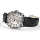 Hamilton American Classic Cushion Mechanical Unisex 34mm Watch H36149710 is captured at a 3/4 angle, showing the white dial, steel case and black leather strap together. The angle highlights the soft cushion shape and the engraved case finish.