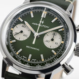 Close-up of Hamilton H38429861 hunter green dial showing pencil hands, Super-LumiNova markers, chronograph sub-dials, and tachymeter scale