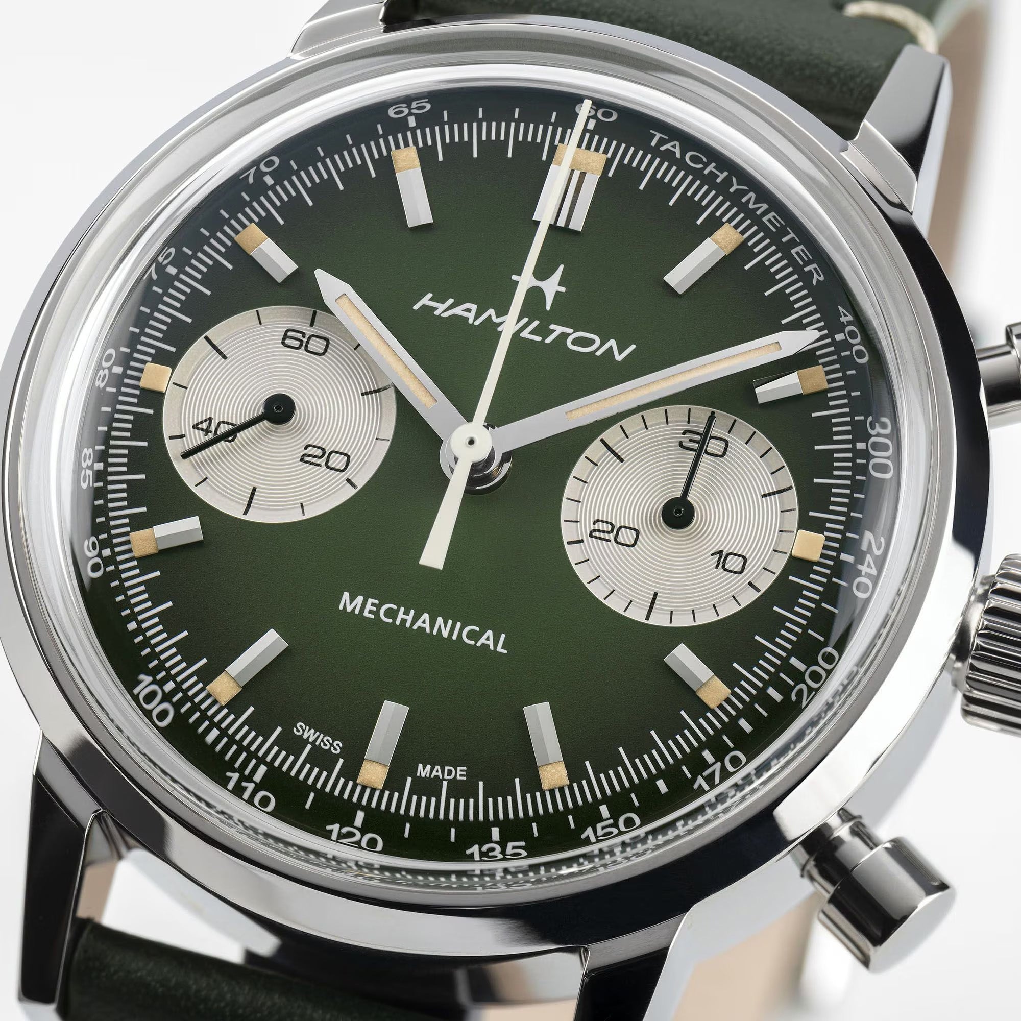 Close-up of Hamilton H38429861 hunter green dial showing pencil hands, Super-LumiNova markers, chronograph sub-dials, and tachymeter scale
