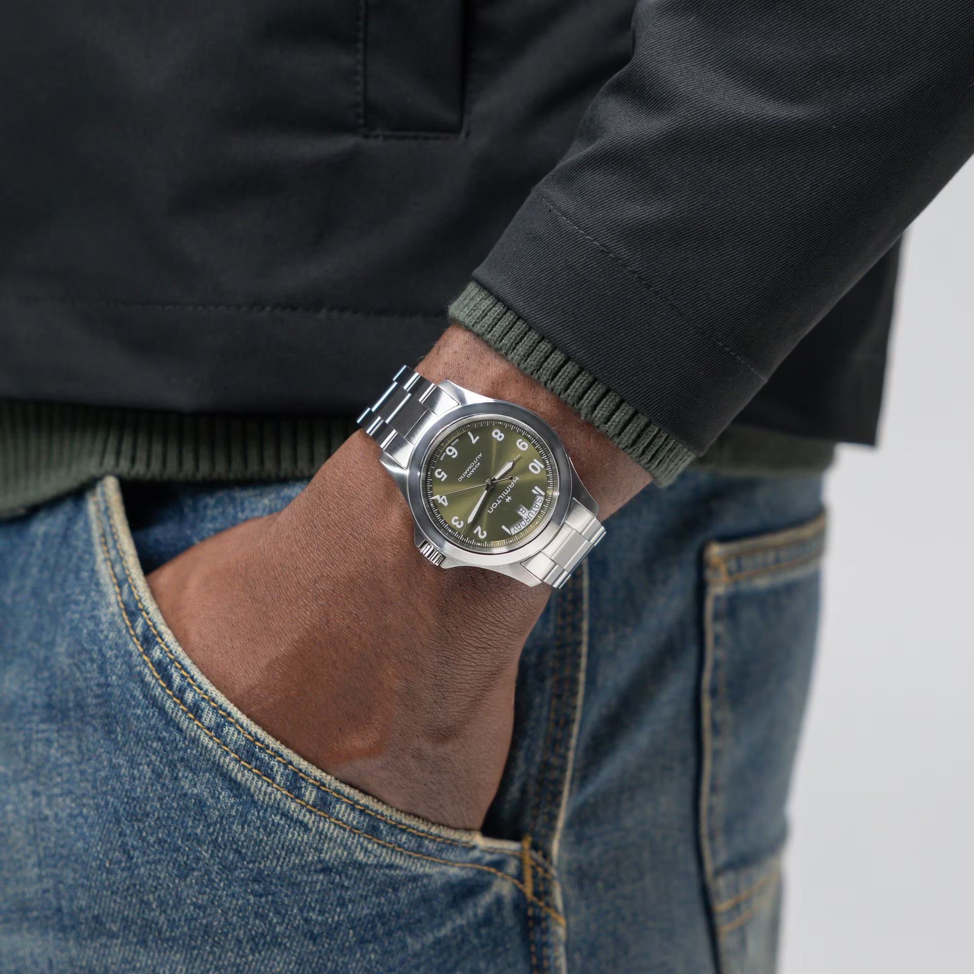 Hamilton Khaki Field King Day-Date H64475160 worn on wrist with casual outdoor clothing, showcasing green dial and steel bracelet