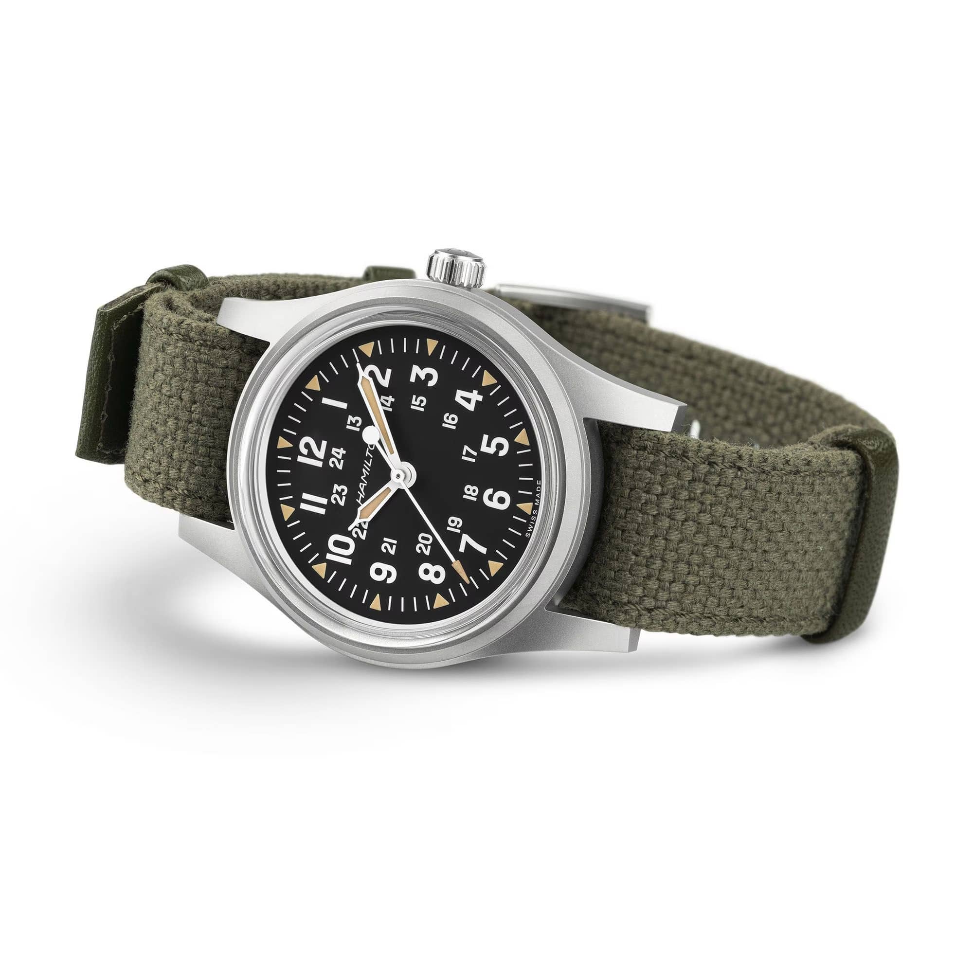 Hamilton Khaki Field Mechanical 36mm Watch H69399930 is shown at a 3/4 angle, highlighting the acrylic box glass, black dial, and khaki NATO strap together. The angle showcases the watch's rugged, purpose-built military design produced exclusively throughout 2026.