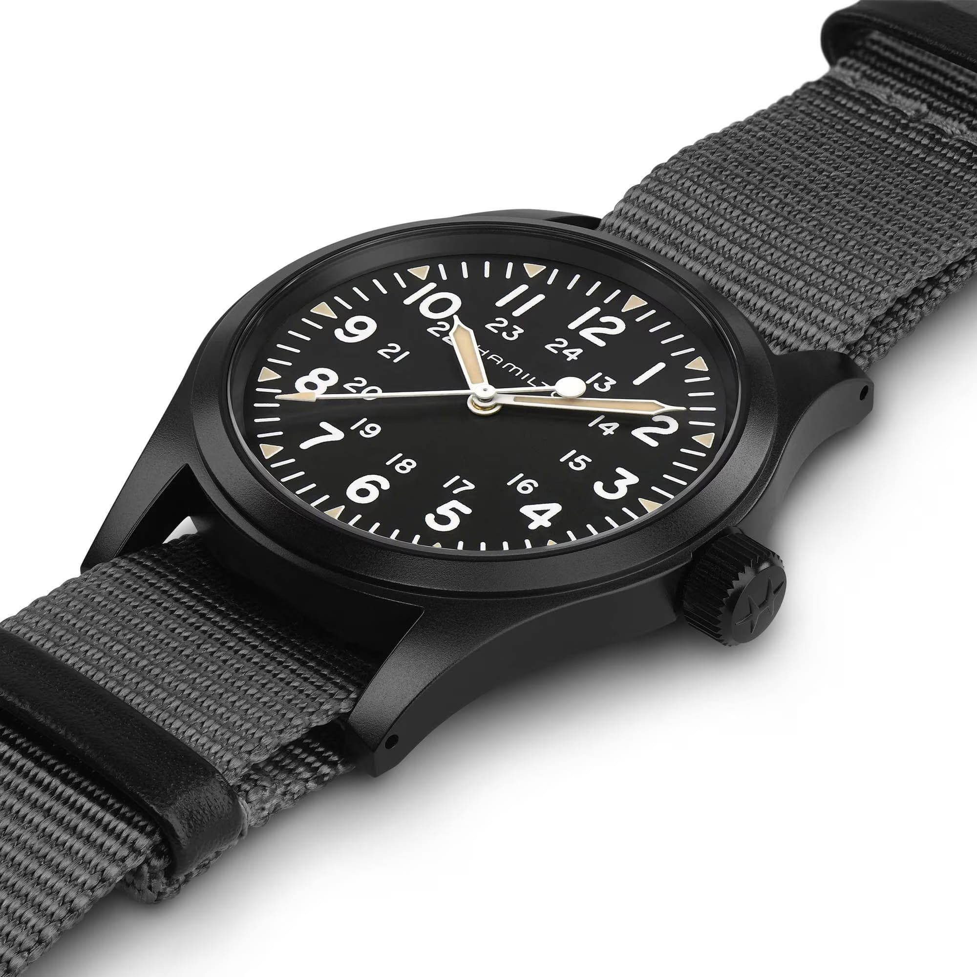 Hamilton Khaki Field Mechanical 38mm Watch H69409930 shows a slim case thickness with a matte black PVD finish over stainless steel. The 20mm lug width and textile strap attachment are visible along the case edge