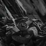 Hamilton Khaki Field Mechanical 38mm Watch H69409930 is shown at a 3/4 angle, highlighting the sapphire crystal, black dial, and NATO strap together. The angle showcases the watch's faithful recreation of its 1960s military field watch origins.