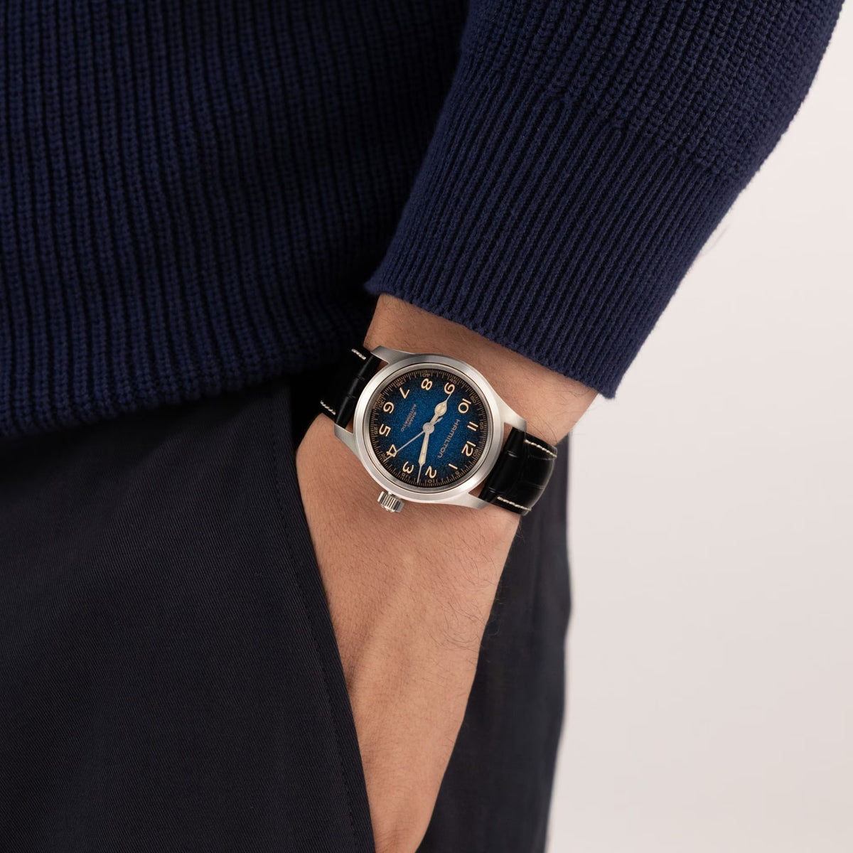 Hamilton Khaki Field Murph Automatic 38mm Watch H70405740 is shown on the wrist, displaying the compact 38mm stainless steel case and black calf leather strap with white contrast stitching. The blue-to-black gradient dial and signature Murph design are clearly visible from this angle.