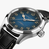 Hamilton Khaki Field Murph Automatic 38mm Watch H70405740 is photographed from the side, revealing the 11.1mm case profile and push-pull crown. The sapphire crystal with anti-reflective coating sits above the gradient dial, protecting it from daily wear and surface scratches.