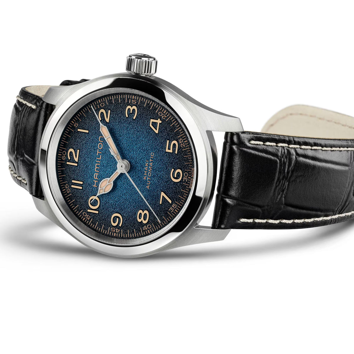 Hamilton Khaki Field Murph Automatic 38mm Watch H70405740 is captured at a 3/4 angle, showcasing the blue-to-black gradient dial, stainless steel case, and black calf leather strap with white contrast stitching. The Interstellar-inspired design and cinematic field watch proportions are prominent from this perspective.