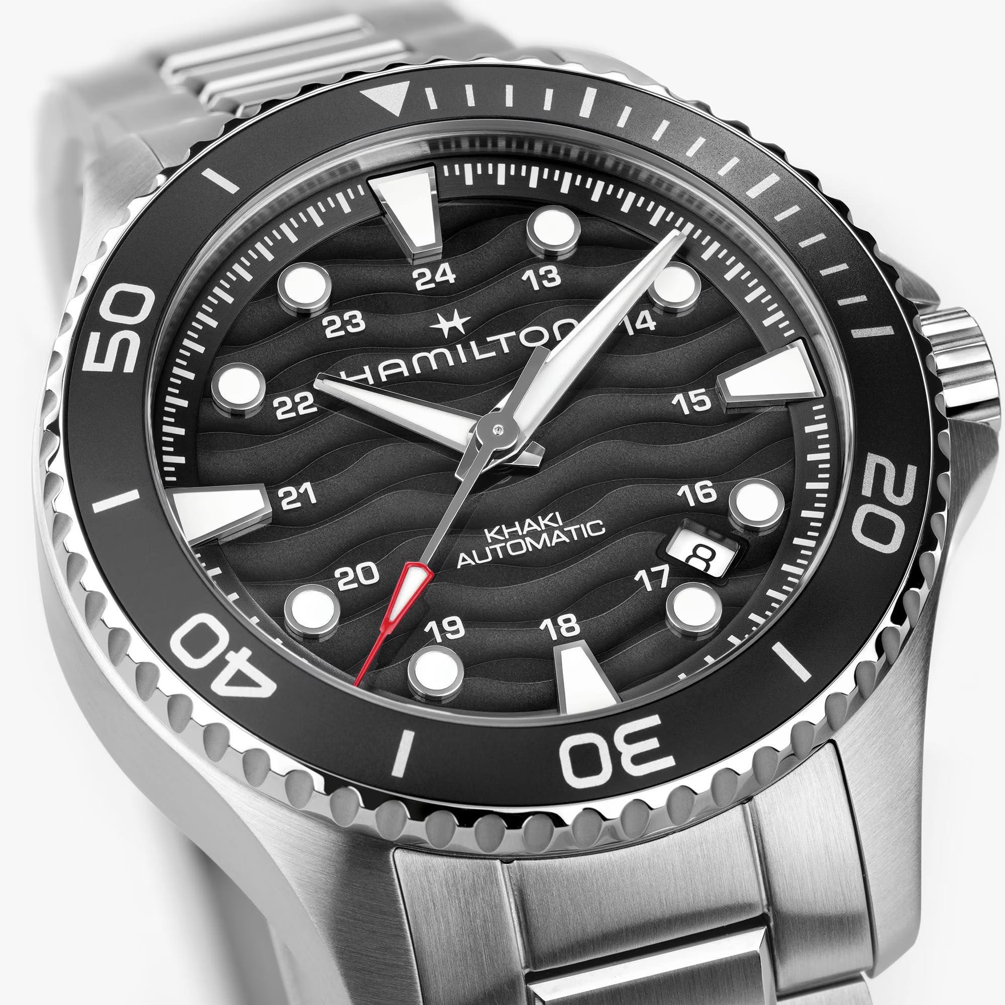 Hamilton Khaki Navy Scuba Auto 40mm Watch H82415130 is shown at a 3/4 angle, highlighting the sapphire crystal, wave-textured black dial, and unidirectional bezel together. The angle showcases the watch's dynamic, diving-inspired design.