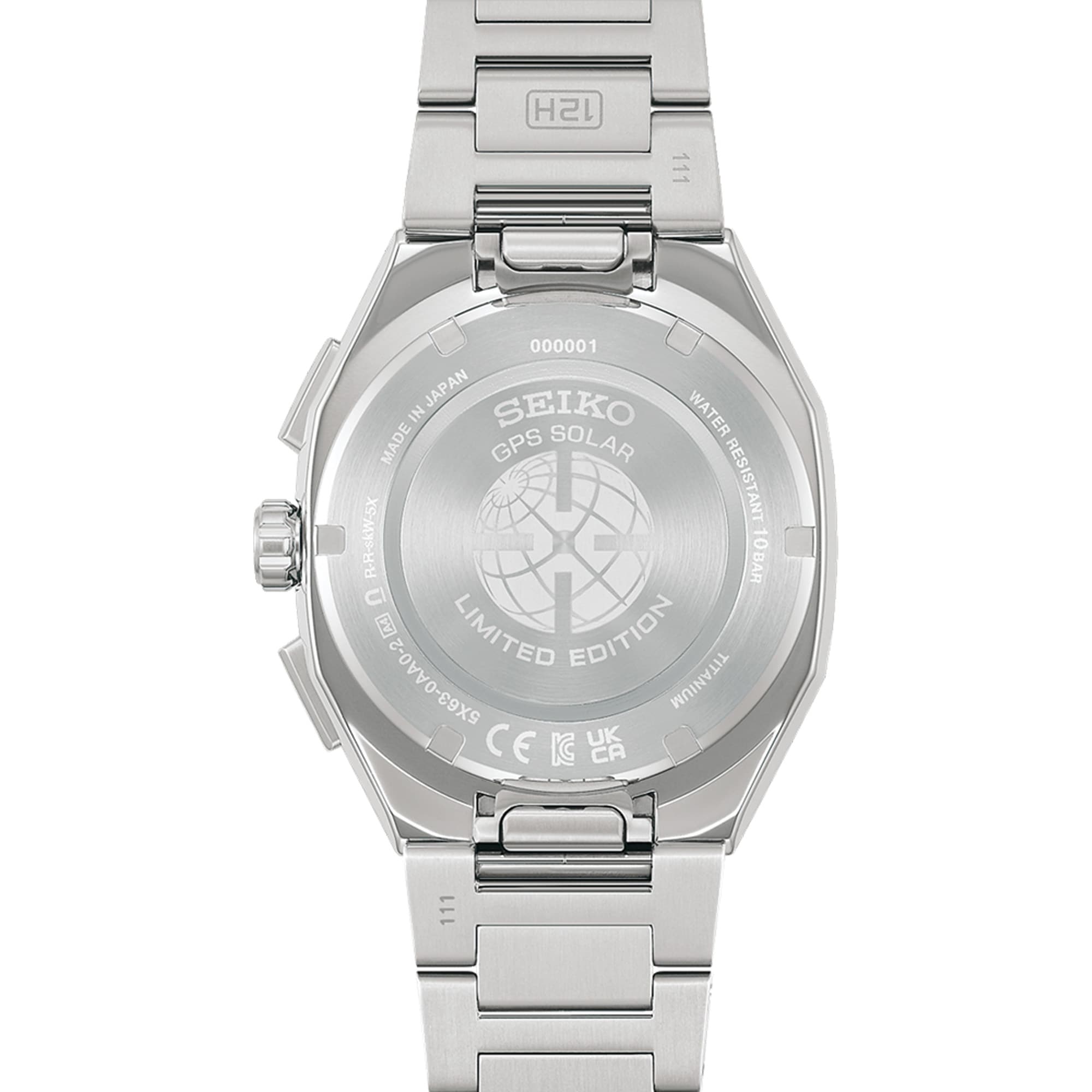 The titanium bracelet connects to the case via Seiko's quick-change system, allowing tool-free swaps with the included blue-and-white silicone strap. The case back is a screwed titanium construction for secure water resistance.