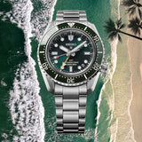 The Seiko Prospex HBC001J features a dark green textured dial with oversized LumiBrite-coated markers, a gold-tone GMT hand and a date window. The 42mm stainless steel case is fitted with a green ceramic unidirectional bezel.
