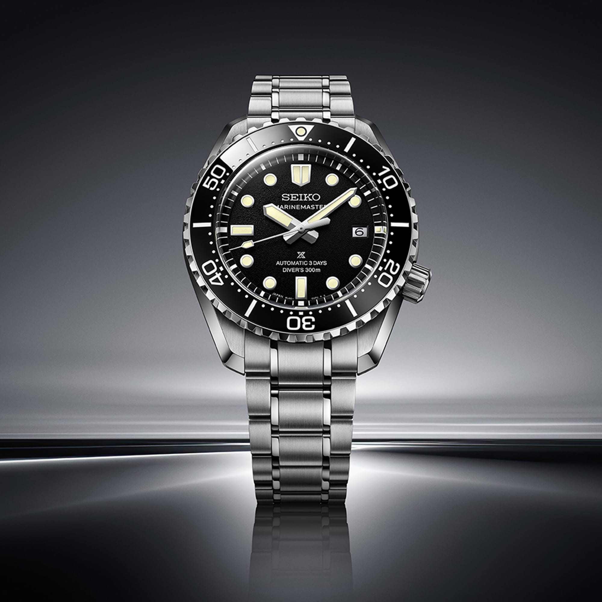 From this angle, the textured black dial, ceramic bezel and LumiBrite markers are visible together against the brushed and polished stainless steel case.