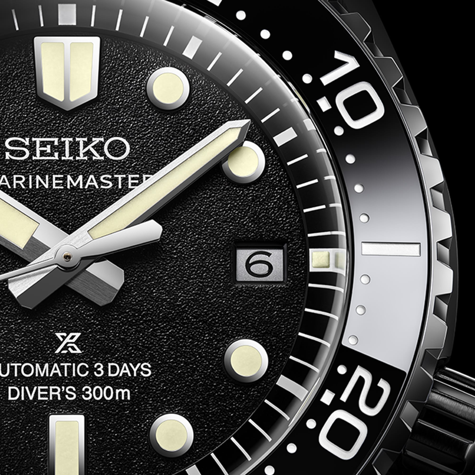 Close-up of a Seiko Seamaster Diver's 300m automatic watch with a black textured dial, silver-tone hands and markers, and a black rotating bezel with white numerals.