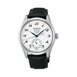 The Seiko Presage Automatic 39.60mm Watch HCC005J features a white hand-made enamel dial with stylised Arabic numerals and a red "12" marker. The 39.6mm stainless steel case is fitted with dual-curved sapphire crystal.
