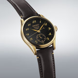 From this angle, the Seiko Presage Automatic 39.60mm Watch HCC006J shows the black urushi dial's depth and gold-lacquer numerals together with the leather strap and gold-coloured case.