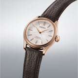 From this angle, the Seiko Presage Automatic 38mm Watch HCC008J shows the dial's pearl-white shimmer and wave pattern together with the pink-gold case and leather strap.