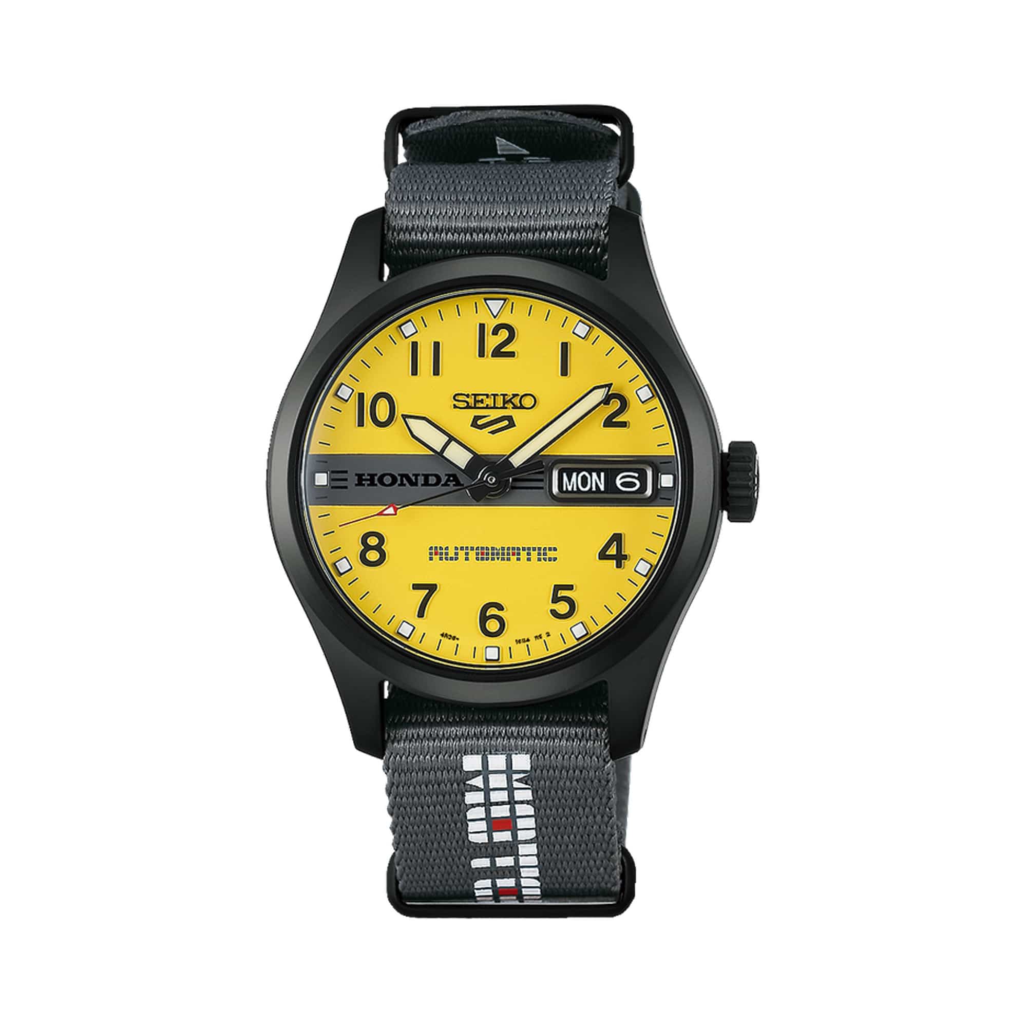 The Seiko 5 Automatic 36.40mm Watch HDB010K features a matte yellow dial with black embossed Arabic numerals, LumiBrite markers and a Honda logo bar. The 36.4mm stainless steel case is fitted with curved Hardlex crystal.