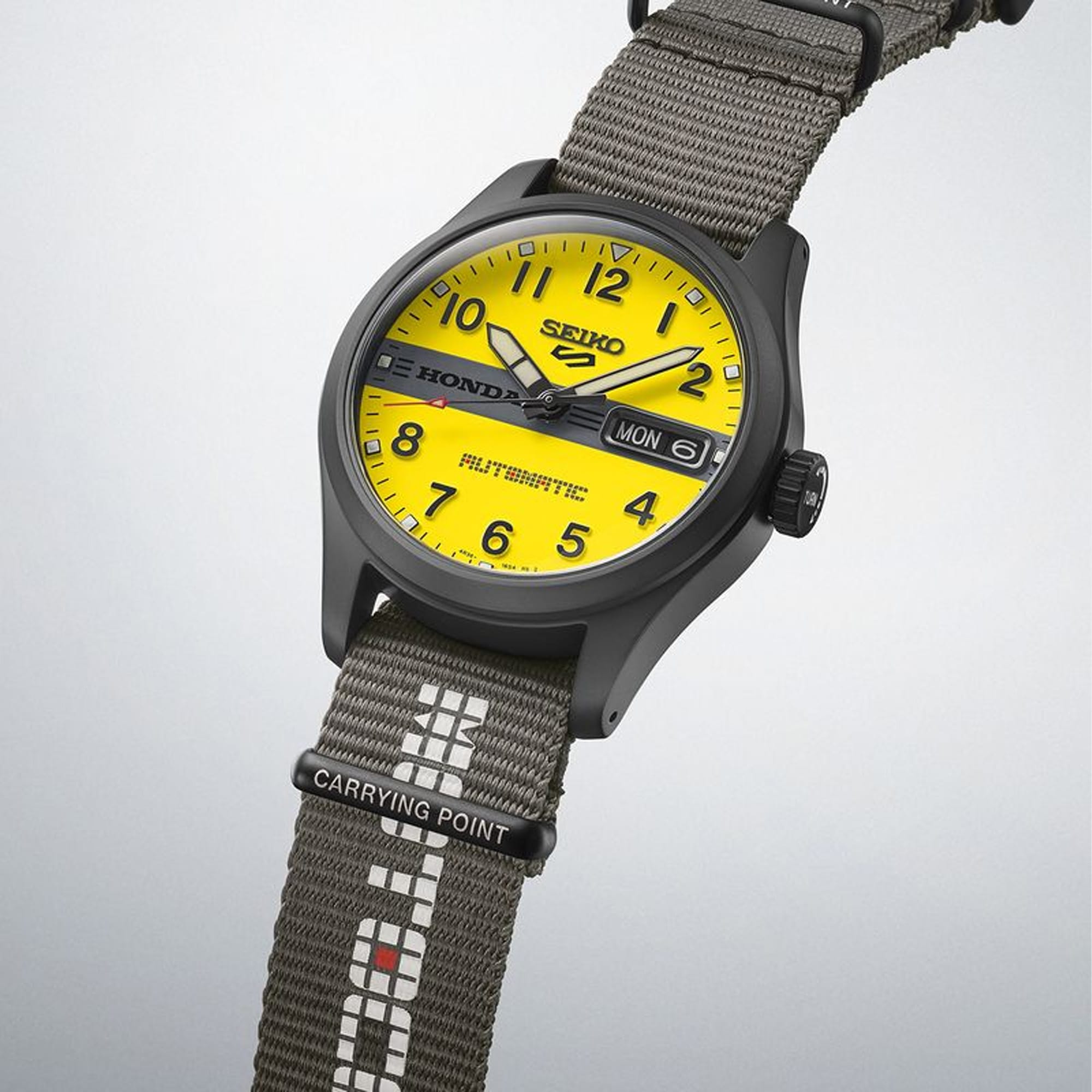 The Seiko 5 Automatic 36.40mm Watch HDB010K reveals the dial's embossed Arabic numerals, Honda logo bar and "TURN" engraved crown in close detail.