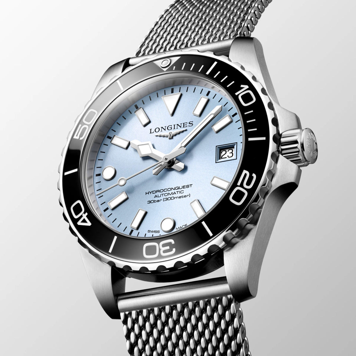 Angled front view of the Longines HydroConquest Automatic 39mm L3.779.4.99.6, highlighting the unidirectional rotating bezel with black ceramic insert and the mesh bracelet. The 39mm stainless steel case strikes a balance between sport performance and everyday elegance.