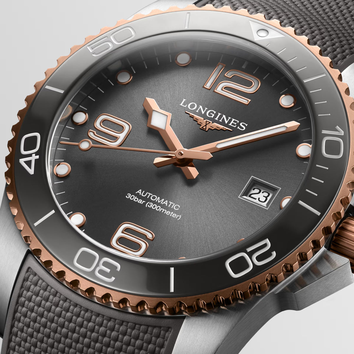 The Longines Hydro Conquest Automatic Men’s 41mm Watch L3.781.3.78.9 reveals the sunray finish of its grey dial, applied numerals and rose gold-tone hands in close detail.