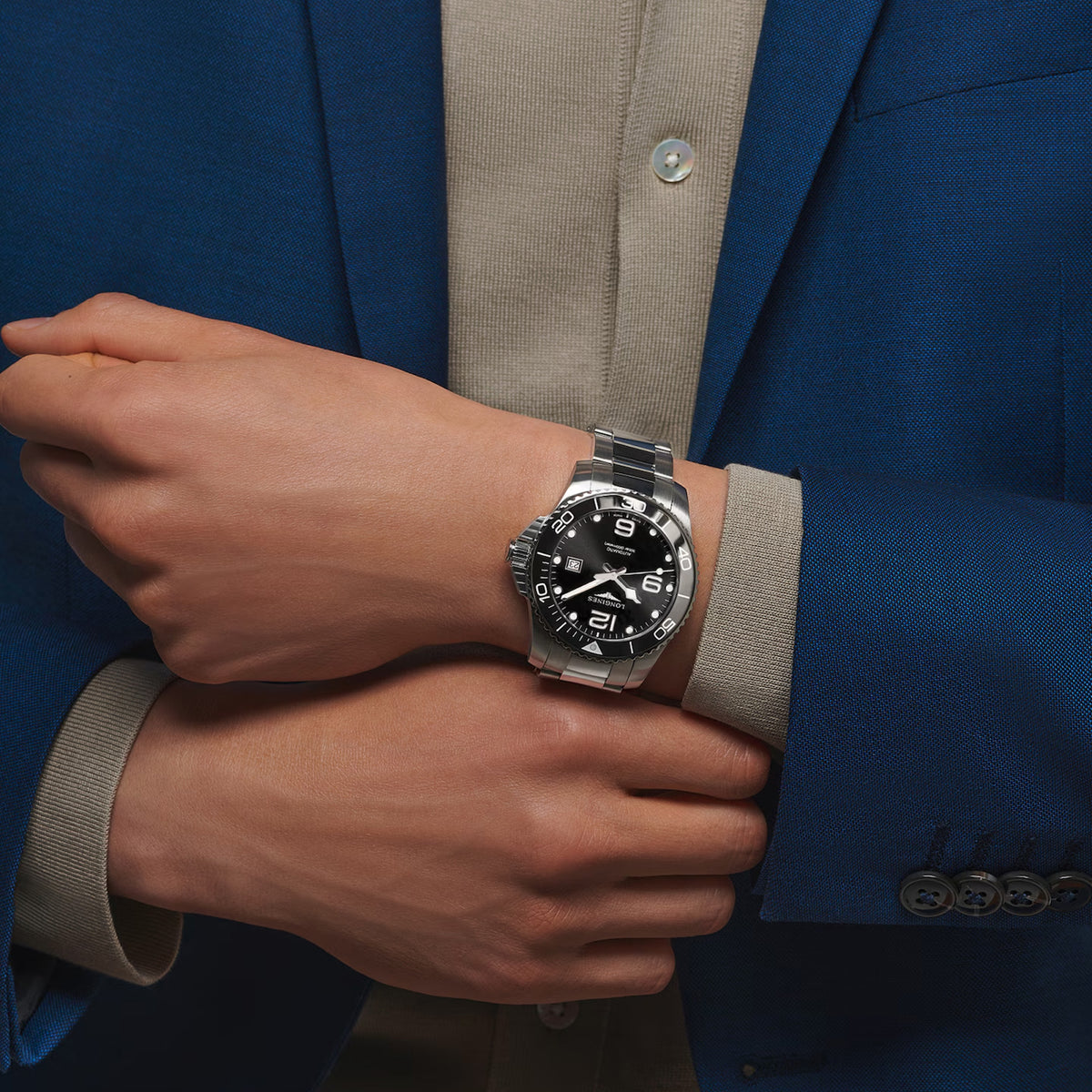 The Longines HydroConquest Automatic Men's 43mm Watch L3.782.4.56.6 worn on the wrist, showing its bold sports watch presence. The black dial, ceramic bezel and stainless steel bracelet suit both diving and everyday wear.