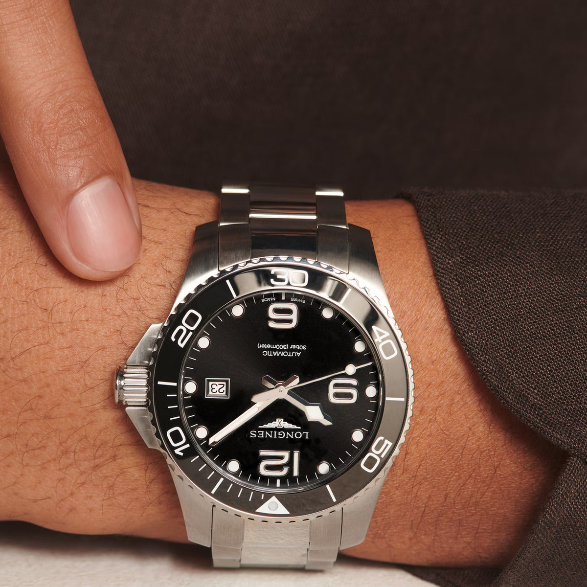Close-up of the black dial on the Longines HydroConquest Automatic Men's 43mm Watch L3.782.4.56.6, showing the hour markers, hands and date window. The black ceramic bezel with its 60-minute dive scale sits around the dial beneath scratch-resistant sapphire crystal.